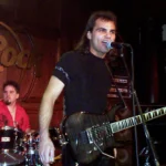 Anthony Vincent live at Hard Rock Cafe playing electric guitar with drummer in background